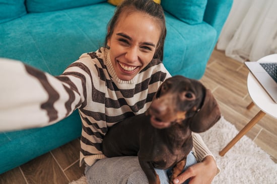 A woman takes a selfie with her dog