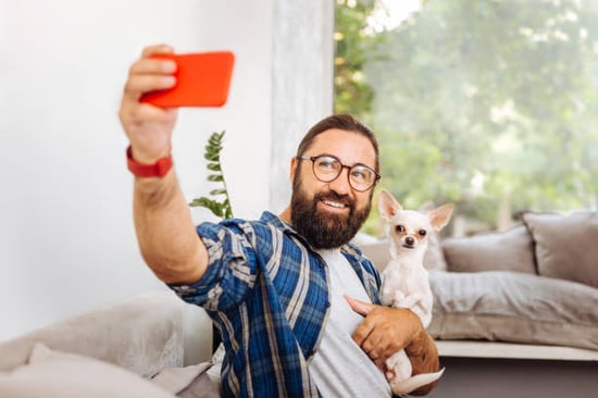 pet parent taking selfie with chihuahua influencer dog
