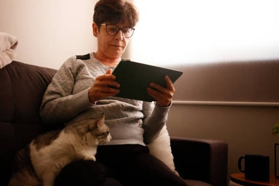 pet parent with automated reminder on tablet