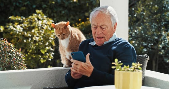cat dad and his pet leaving a review on his smartphone