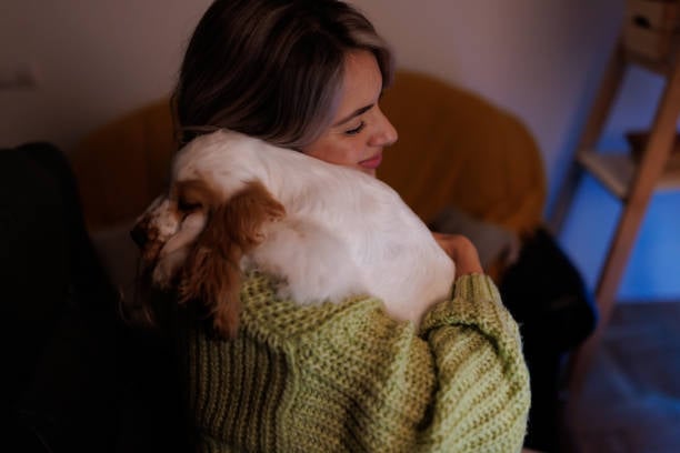 woman holding and hugging a tired pup