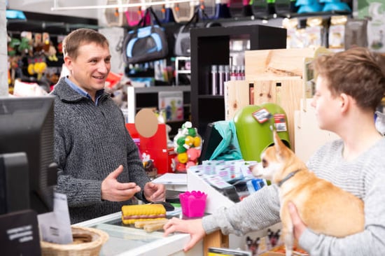 pet business owner and client with dog at checkin