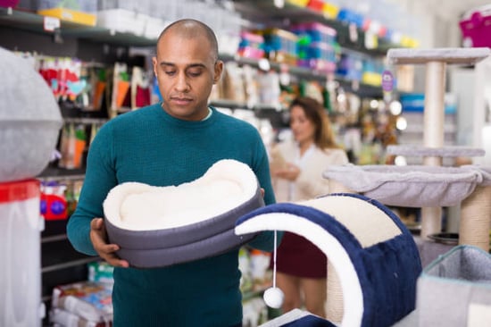 pet-care team member stocking up on supplies at the pet store