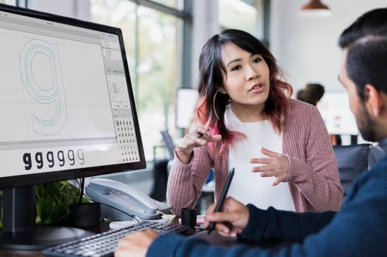 business owner working with designer to create company logo