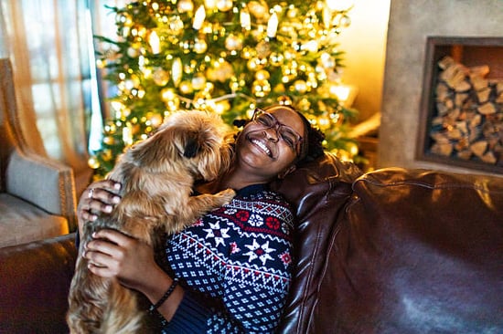 pet parent and affectionate dog with holiday decor