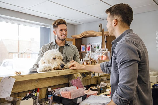 small business owner delivering great customer service to client and dog