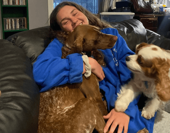 ceo sophie cuddling dogs